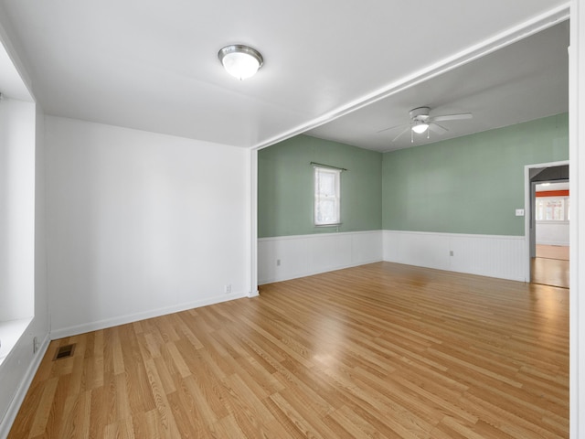 spare room with light hardwood / wood-style floors and ceiling fan