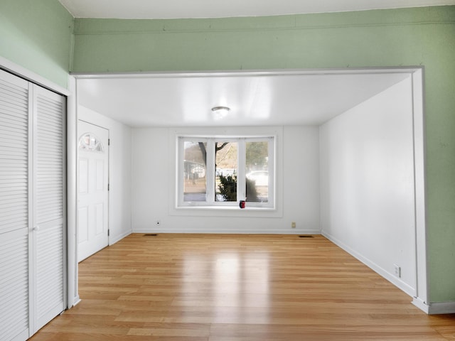 unfurnished bedroom featuring light hardwood / wood-style flooring and a closet