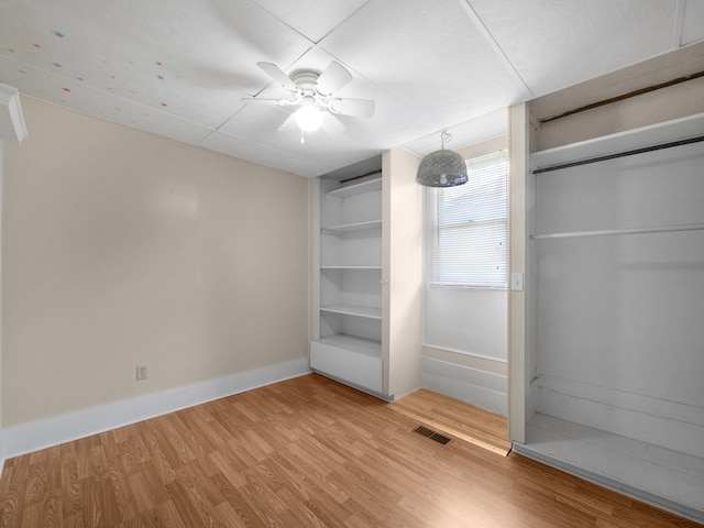 unfurnished bedroom featuring hardwood / wood-style flooring and ceiling fan