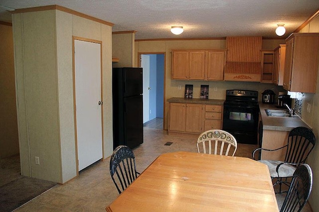 kitchen with crown molding, sink, a textured ceiling, and black appliances