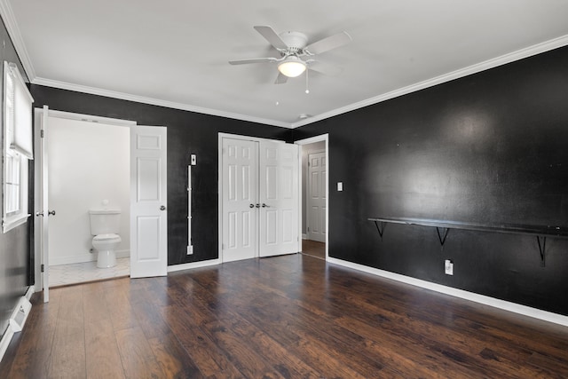 unfurnished bedroom featuring ceiling fan, ornamental molding, connected bathroom, and dark hardwood / wood-style flooring