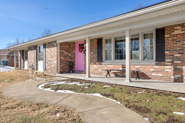 view of exterior entry featuring covered porch