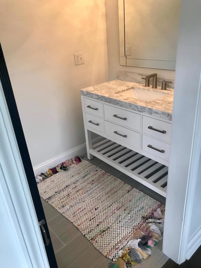 bathroom with baseboards and vanity