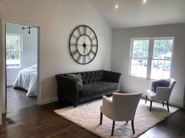 living room featuring lofted ceiling, visible vents, dark wood finished floors, and baseboards