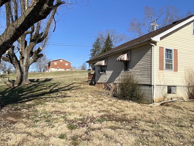 view of side of property with a yard