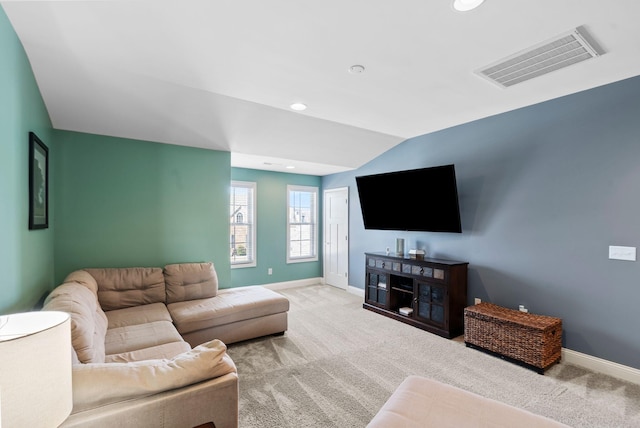 carpeted living room featuring vaulted ceiling