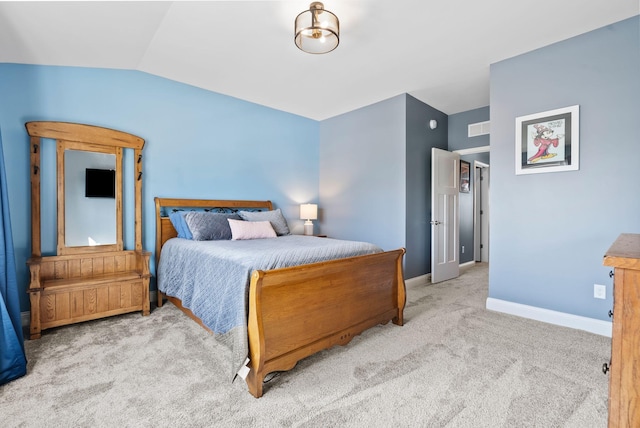 bedroom with vaulted ceiling and light carpet