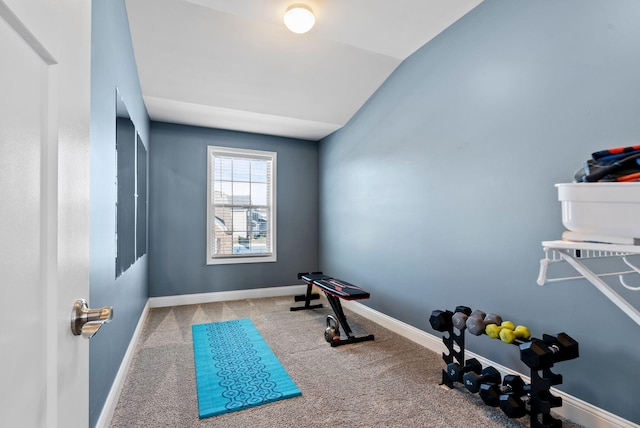 exercise room with lofted ceiling and carpet floors