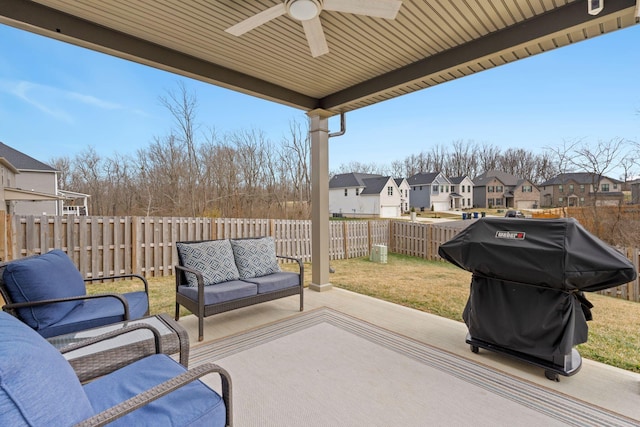 view of patio with ceiling fan, area for grilling, and an outdoor living space