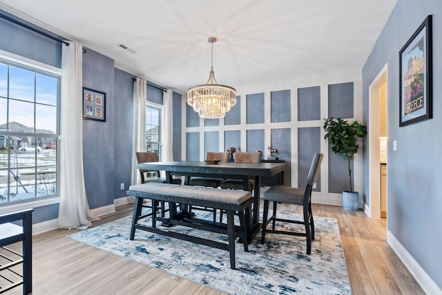 dining room featuring an inviting chandelier and light wood-type flooring