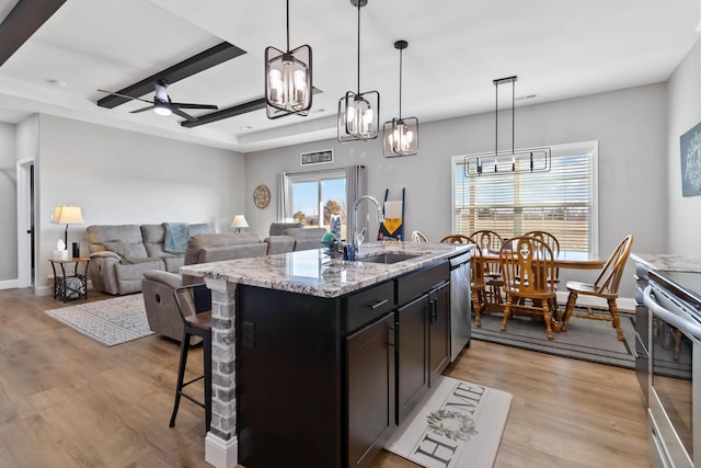 288 Liam Way, Paint Lick, KY 40461 - kitchen with light wood finished floors, a breakfast bar area, a sink, and ceiling fan with notable chandelier