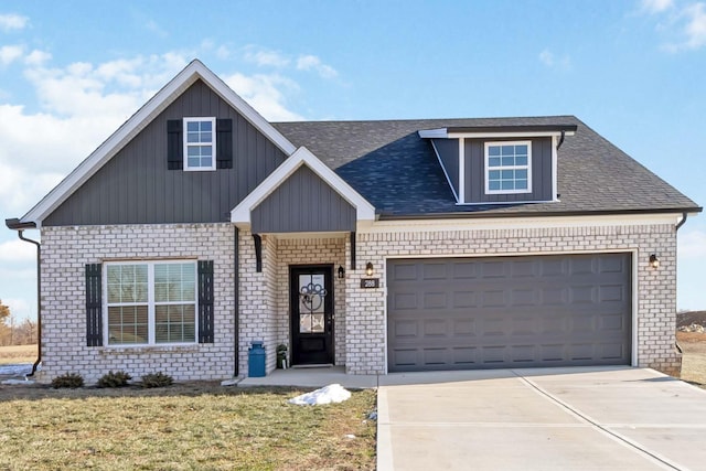 view of front of property featuring a garage, concrete driveway, roof with shingles, a front lawn, and brick siding