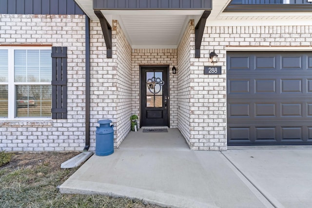 288 Liam Way, Paint Lick, KY 40461 - property entrance featuring a garage, brick siding, and board and batten siding