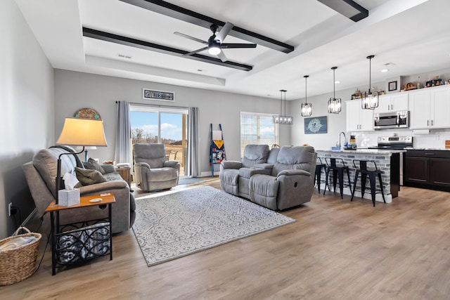 288 Liam Way, Paint Lick, KY 40461 - living area featuring ceiling fan with notable chandelier, a tray ceiling, light wood-type flooring, visible vents, and recessed lighting