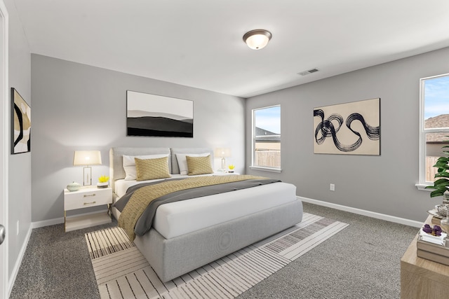 carpeted bedroom featuring multiple windows