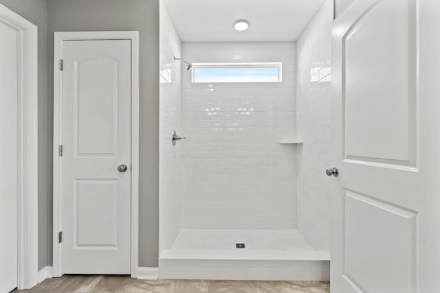 bathroom with a tile shower