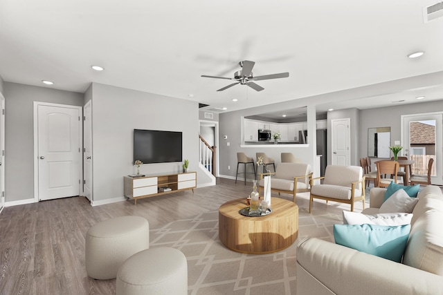 living room with hardwood / wood-style floors and ceiling fan