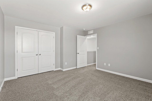 unfurnished bedroom with carpet floors and a closet