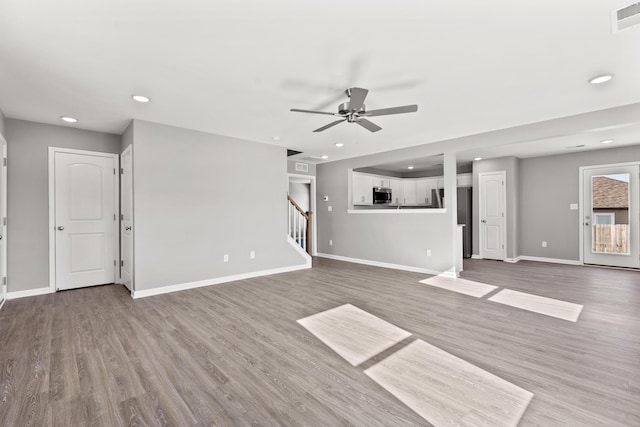 unfurnished living room featuring wood-type flooring and ceiling fan