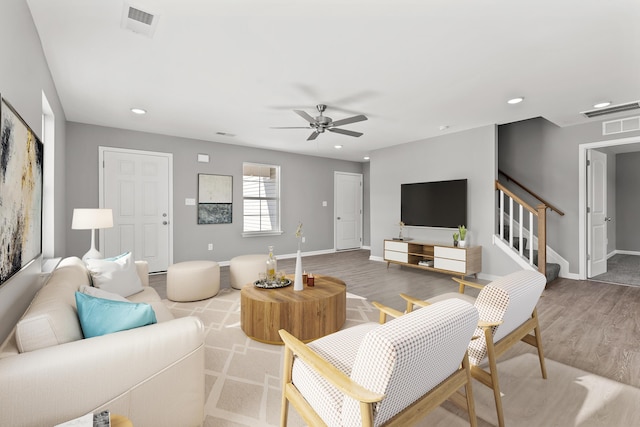 living room featuring ceiling fan and light hardwood / wood-style floors