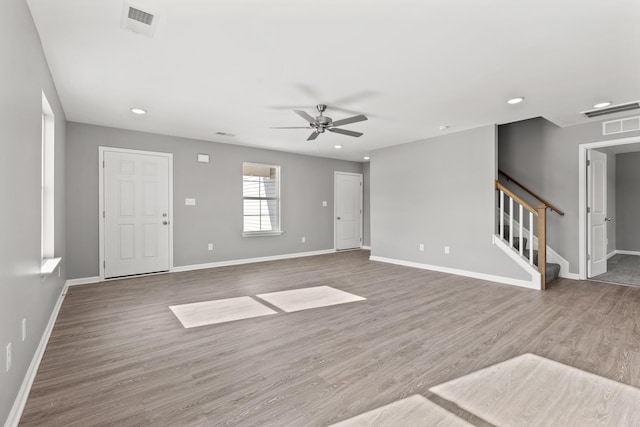 unfurnished living room with hardwood / wood-style floors and ceiling fan