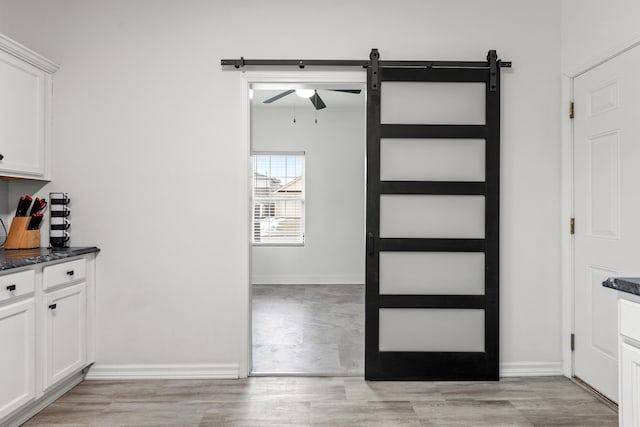 interior space with a barn door and light hardwood / wood-style flooring