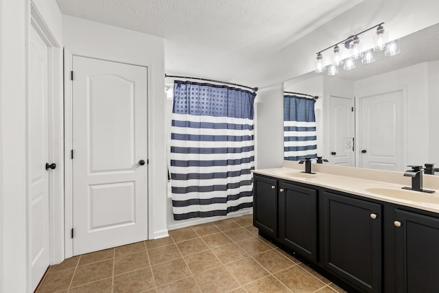 bathroom featuring vanity, tile patterned floors, a textured ceiling, and a shower with curtain