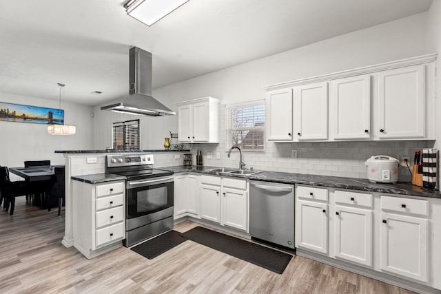 kitchen with island range hood, decorative light fixtures, sink, white cabinets, and stainless steel appliances