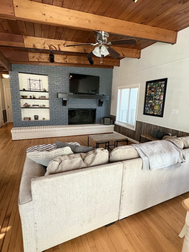 living room with wood ceiling, wood-type flooring, and a brick fireplace