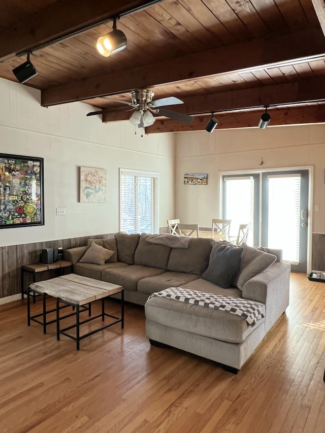 living room with light hardwood / wood-style flooring, wooden ceiling, and rail lighting