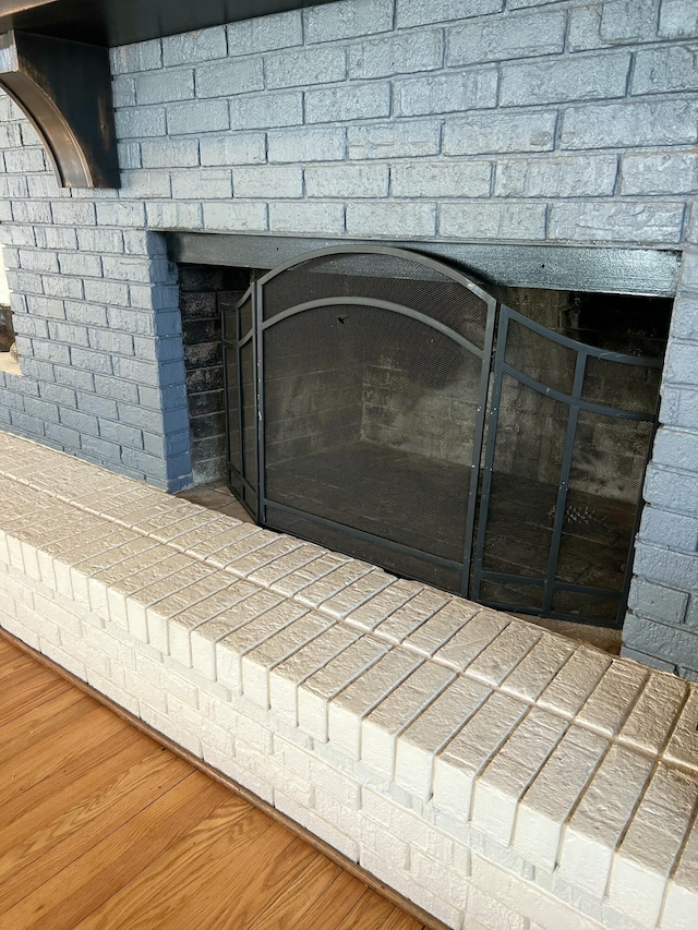 room details featuring hardwood / wood-style flooring and a fireplace