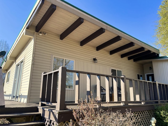 view of property exterior featuring a wooden deck