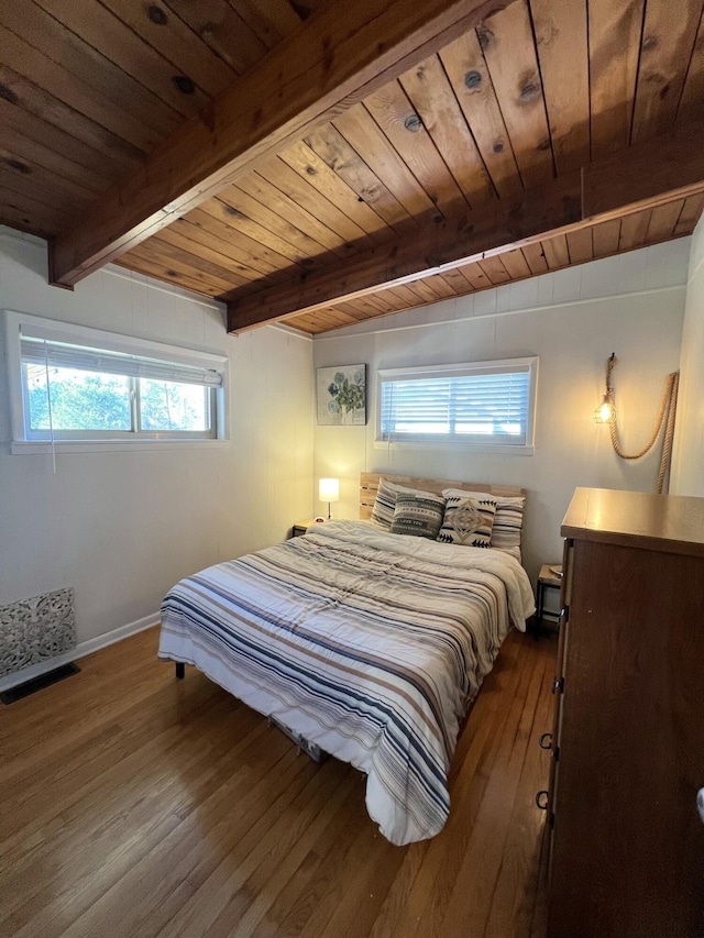 bedroom with beamed ceiling, hardwood / wood-style floors, and wooden ceiling