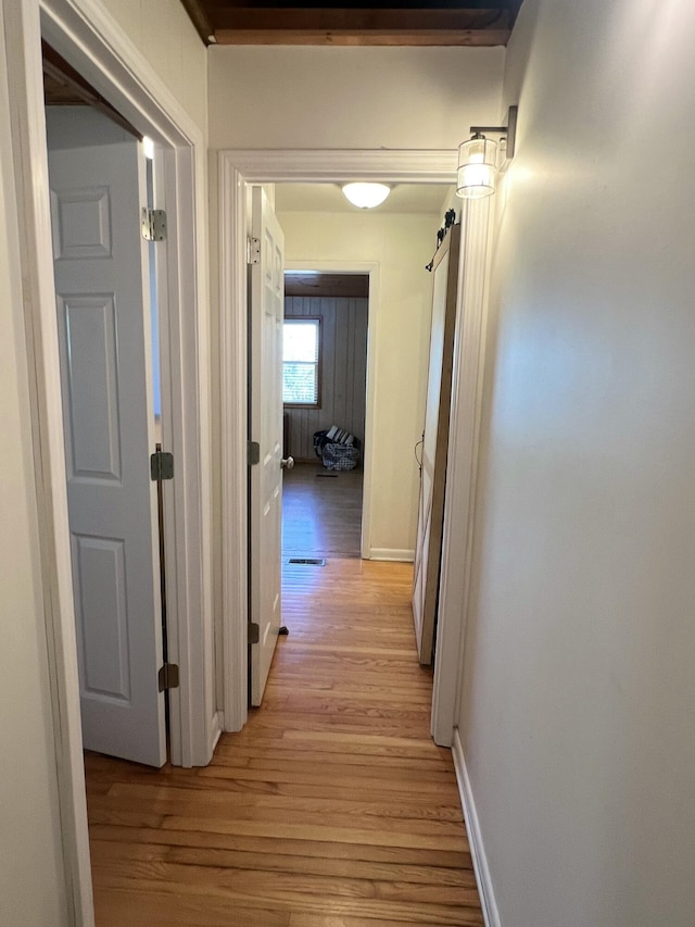 hall with light hardwood / wood-style floors