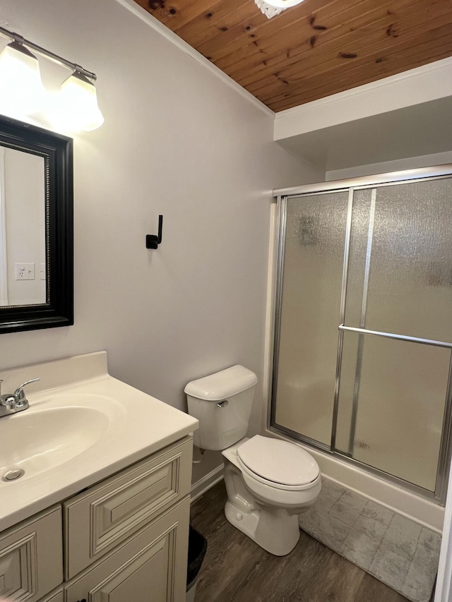 bathroom featuring toilet, wood ceiling, wood-type flooring, vanity, and a shower with door