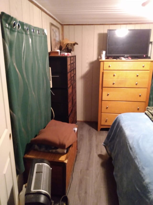 bedroom with hardwood / wood-style flooring and crown molding