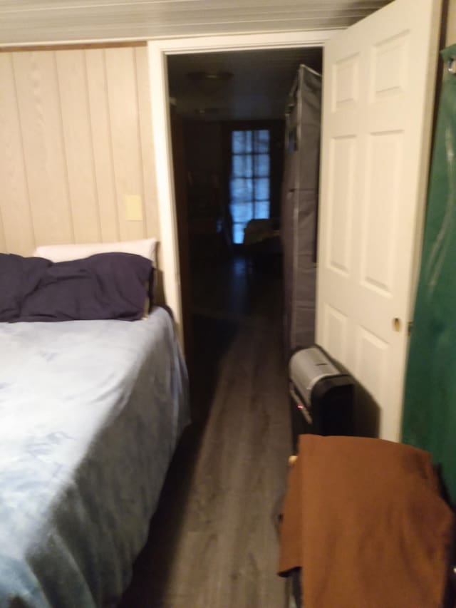 bedroom with dark wood-type flooring