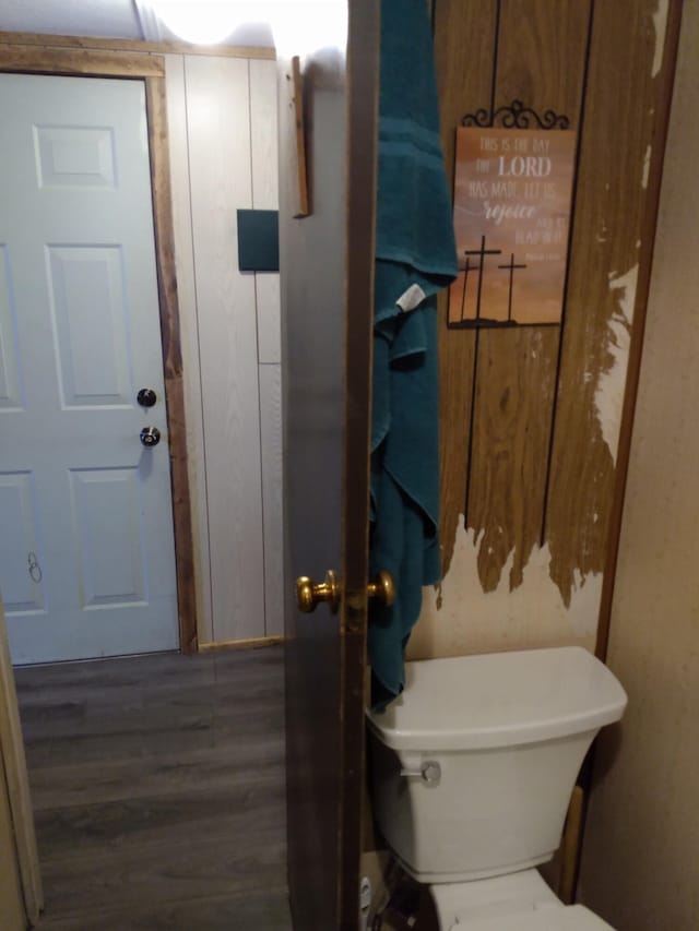 bathroom featuring hardwood / wood-style flooring and toilet