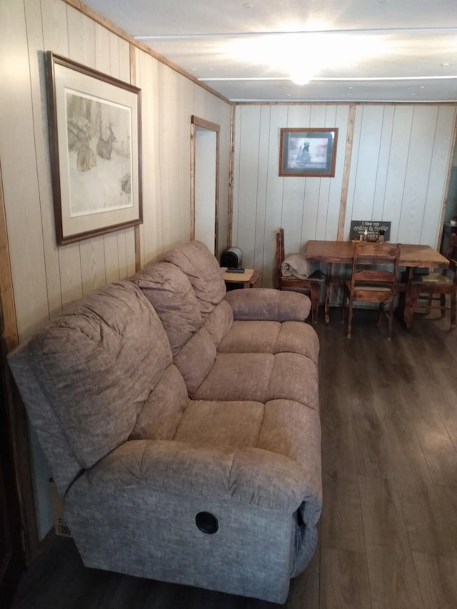 living room with ornamental molding and dark hardwood / wood-style floors