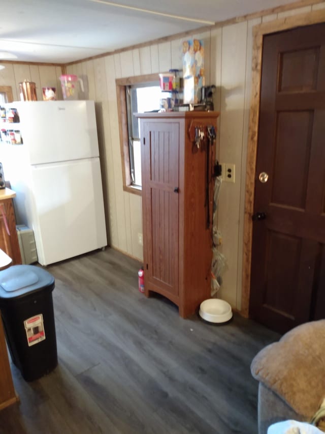 kitchen featuring hardwood / wood-style flooring and white fridge