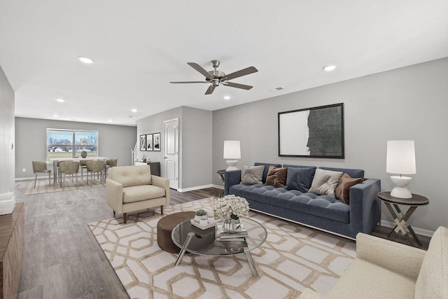 living room with hardwood / wood-style floors and ceiling fan