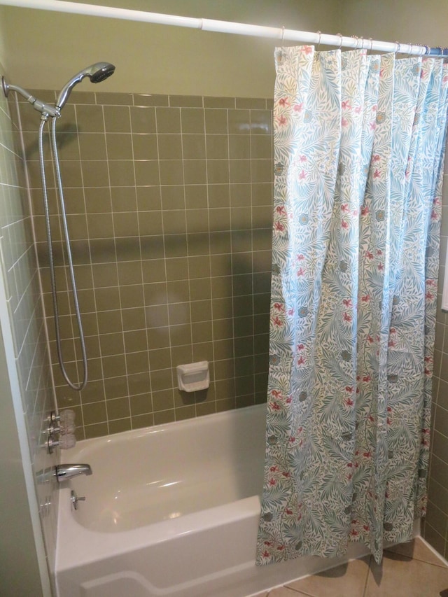 bathroom featuring tile patterned flooring and shower / bathtub combination with curtain