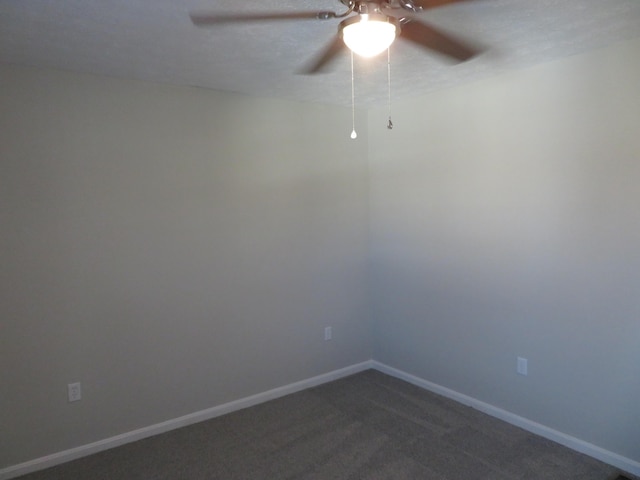 carpeted spare room featuring ceiling fan and a textured ceiling