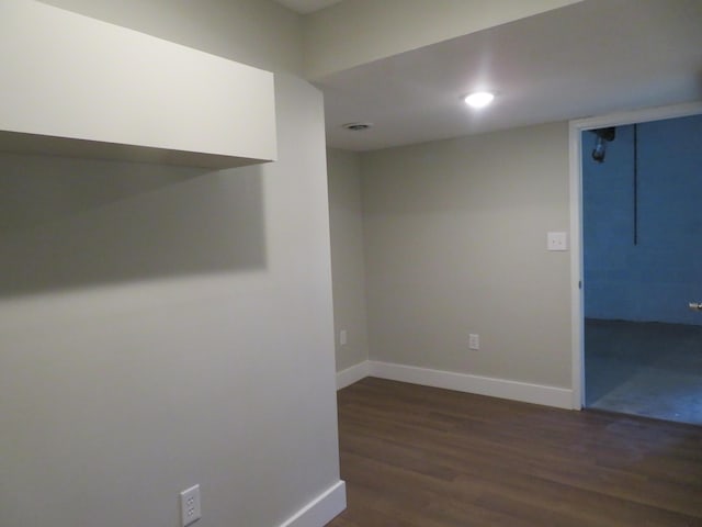 spare room with dark wood-type flooring