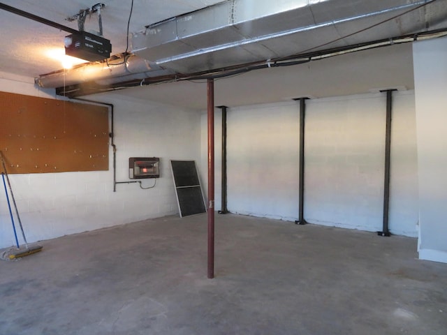 garage featuring a garage door opener and heating unit