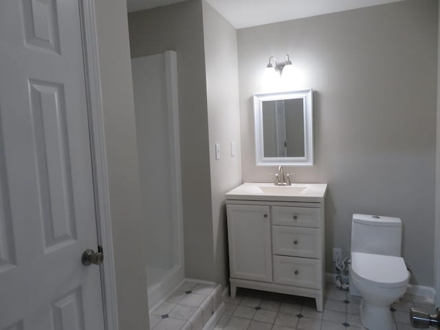 bathroom featuring tile patterned floors, vanity, and toilet