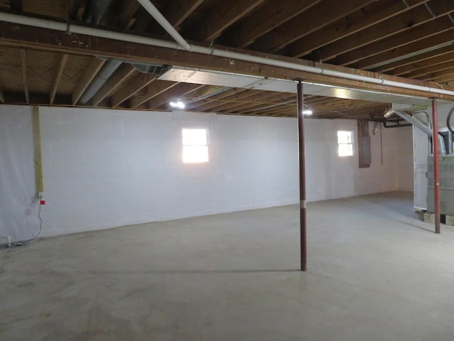 basement featuring heating unit and electric panel