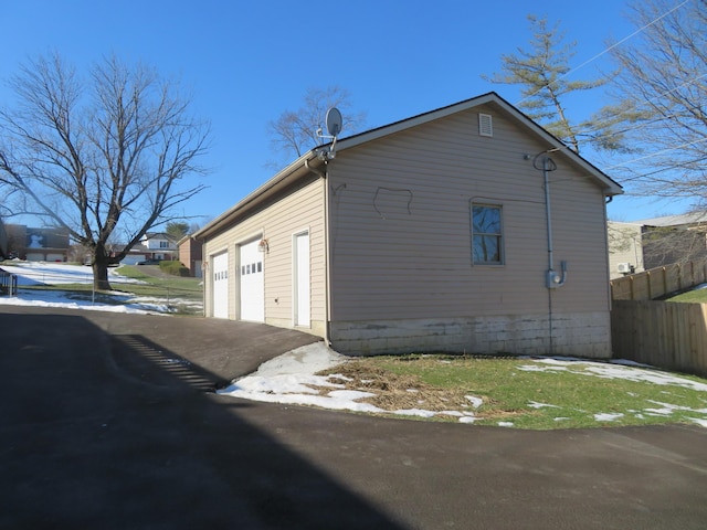 view of side of home featuring a garage