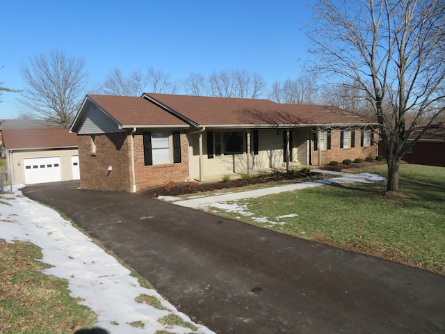 ranch-style house with a garage and a front lawn