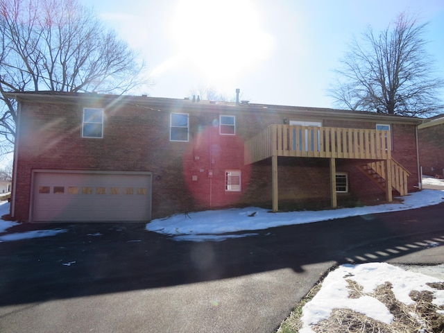 snow covered property featuring a garage